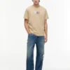 Tommy Jeans T-Shirt mit Multi-Crest-Logo Tommy Jeans T-Shirt mit Multi-Crest-Logo